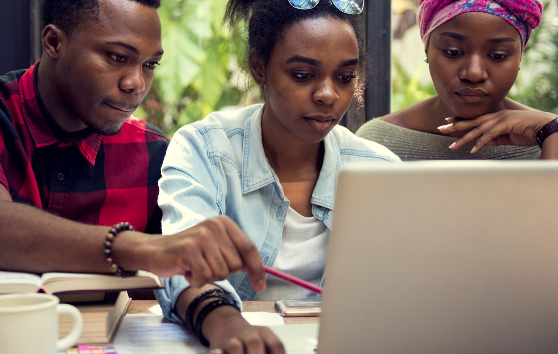 Learners working together on a laptop